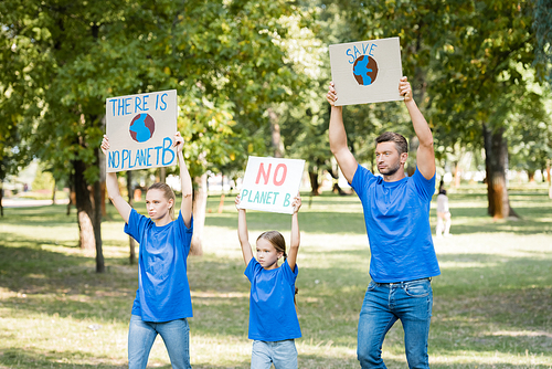 family holding posters with globe, there is no planet b planet, and save inscription in raised hands, ecology concept