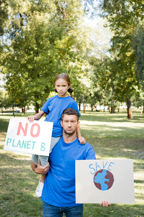 father and daughter holding placards with globe and no planet b inscription, ecology concept
