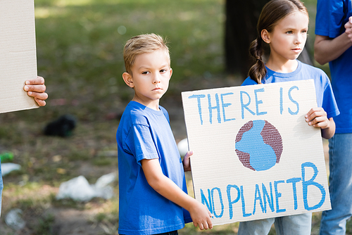 children holding placard with globe and there is no planet b inscription near parents, ecology concept