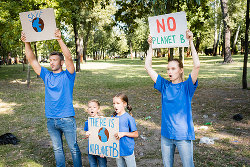 family of volunteers screaming while holding placards with globe and no planet b inscription, ecology concept
