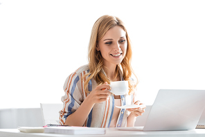 Selective focus of woman smiling and holding cup