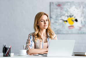 Selective focus of concentrated woman working with laptop
