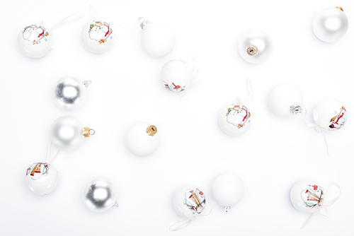 top view of silver and  white baubles on white background