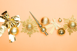 top view of festive golden christmas decoration on orange background