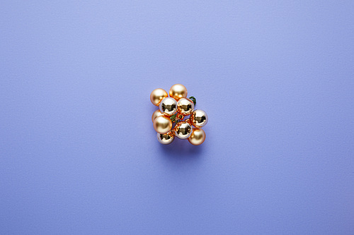 top view of shiny golden Christmas decoration on blue background