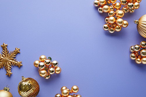 top view of shiny golden Christmas decoration on blue background with copy space