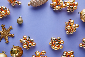 top view of shiny golden Christmas decoration on blue background with copy space