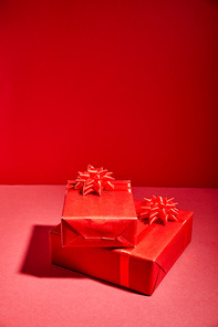 red Christmas gift boxes on red background