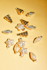 golden Christmas baubles on yellow background
