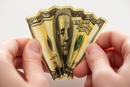 cropped view of woman holding crumpled dollar banknote in hands isolated on white