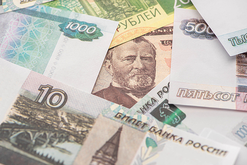 selective focus of russian rubles near dollar banknote