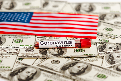 american flag and coronavirus blood sample on dollar banknotes, economic crisis concept