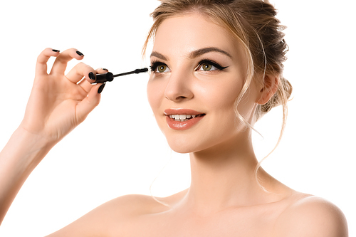 smiling naked beautiful blonde woman with makeup and black nails applying mascara isolated on white