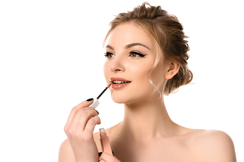 naked beautiful blonde woman with makeup and black nails applying beige lip gloss isolated on white