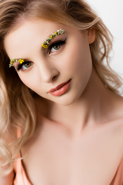 beautiful blonde woman with wildflowers on eyebrows isolated on white