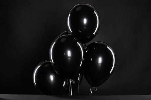 bunch of black balloons isolated on black, black Friday concept