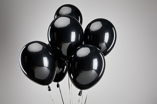 bunch of black balloons isolated on grey, black Friday concept