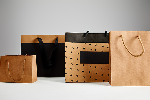 paper shopping bags isolated on grey, black Friday concept