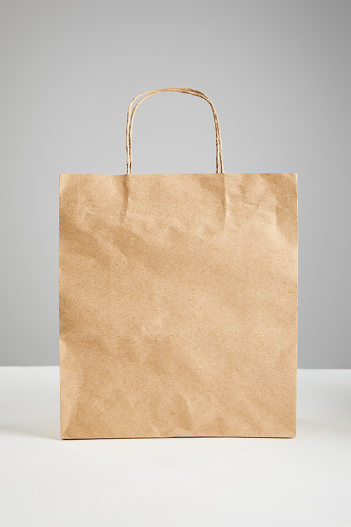 paper shopping bag isolated on grey, black Friday concept