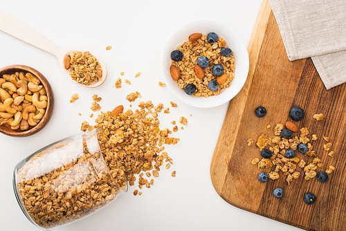 top view of delicious granola with nuts, blueberry and dried apricots isolated on white