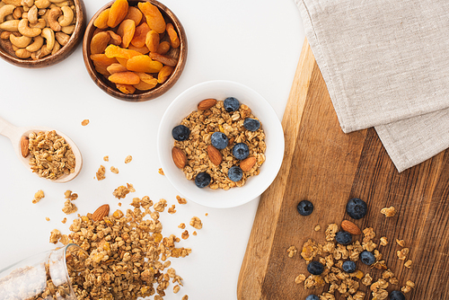 top view of delicious granola with nuts, blueberry and dried apricots isolated on white