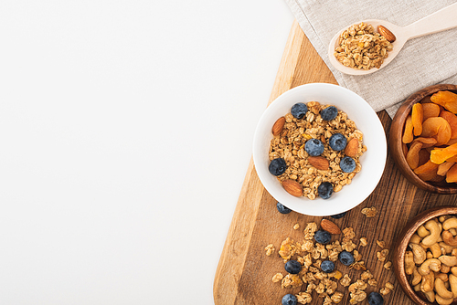 top view of delicious granola with nuts, blueberry and dried apricots isolated on white