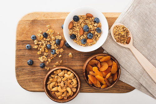 top view of delicious granola with nuts, blueberry and dried apricots isolated on white