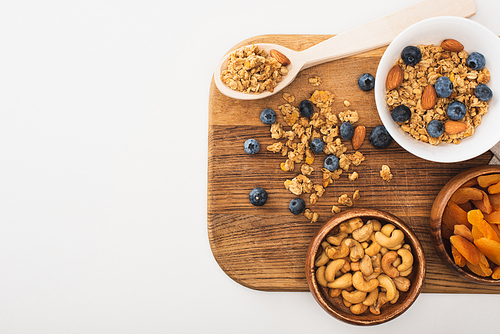 top view of delicious granola with nuts, blueberry and dried apricots isolated on white