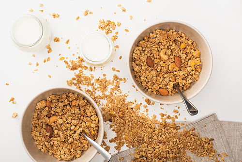 top view of delicious granola with nuts, yogurt isolated on white