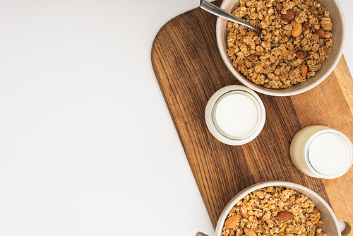 top view of delicious granola with nuts, yogurt isolated on white