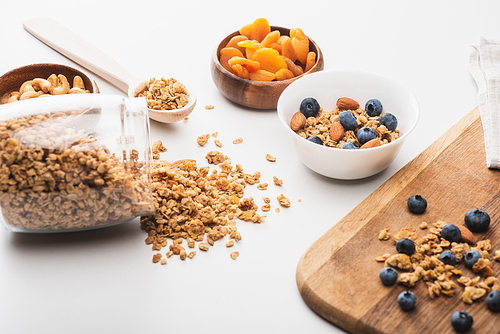 delicious granola with nuts,dried apricots and blueberry on white background