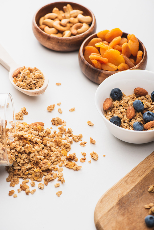 delicious granola with nuts,dried apricots and blueberry on white background