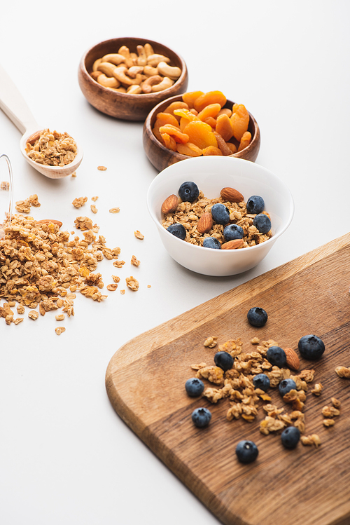 delicious granola with nuts,dried apricots and blueberry on white background