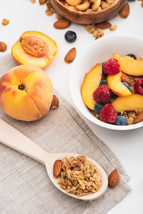 delicious granola with nuts and fruits on white background