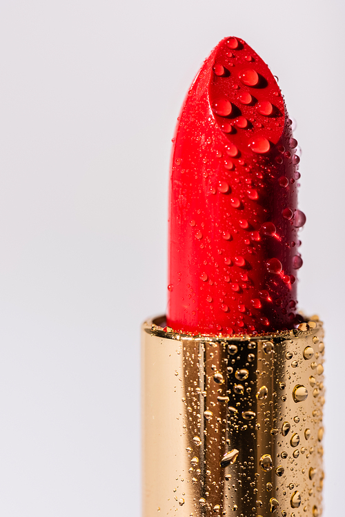 close up view of red wet lipstick isolated on white