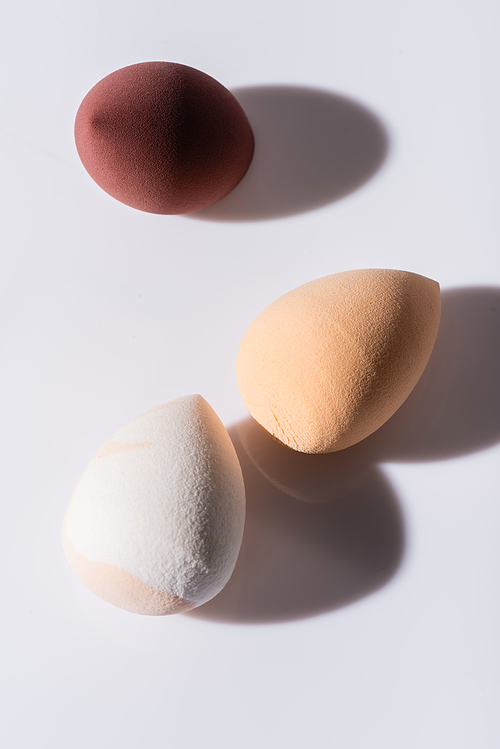 top view of makeup sponges on white background
