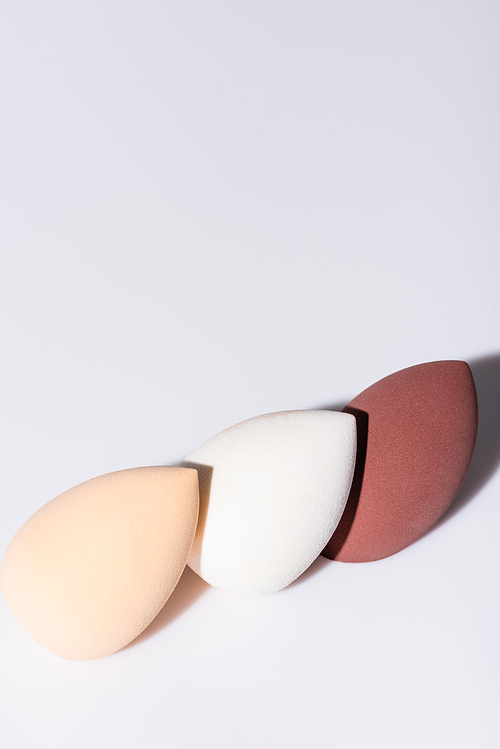 makeup sponges on white background with copy space