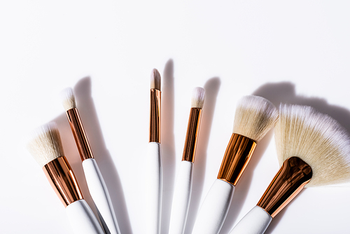 top view of cosmetic brushes set on white background