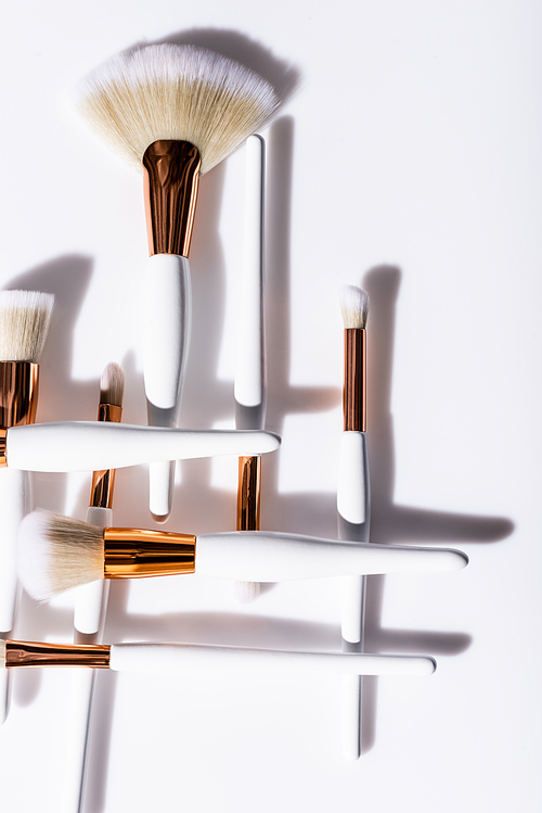 flat lay with cosmetic brushes set on white background