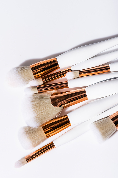 top view of cosmetic brushes set on white background