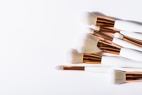 top view of cosmetic brushes set on white background with copy space