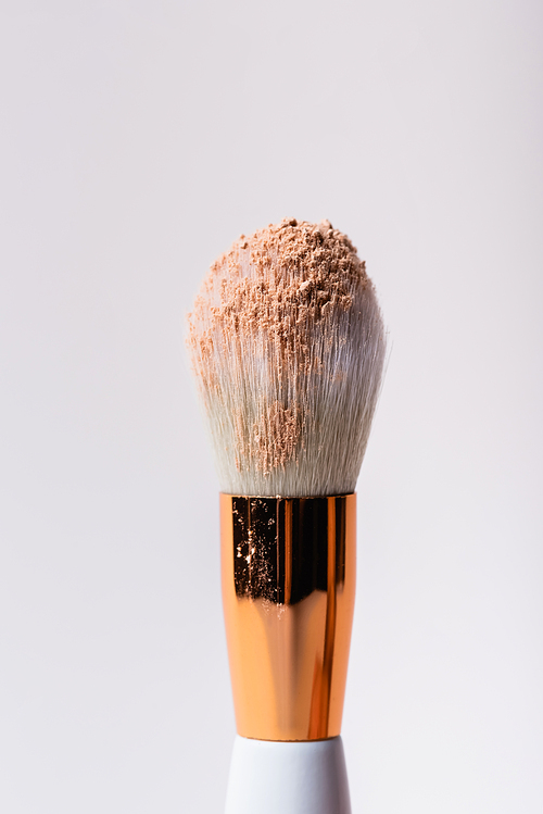 close up view of cosmetic brush with face powder isolated on white