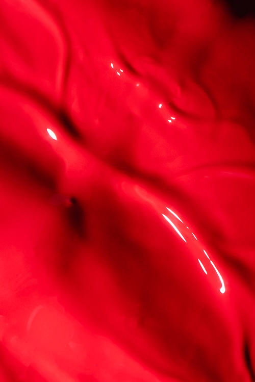 close up view of red liquid lipstick texture