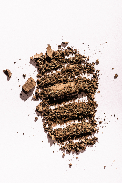 top view of brown eyeshadow powder on white background