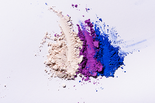 top view of purple, blue and white eyeshadow powder