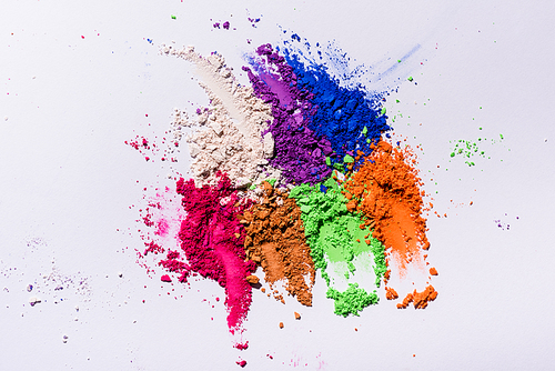 top view of multicolored eyeshadow powder on white background