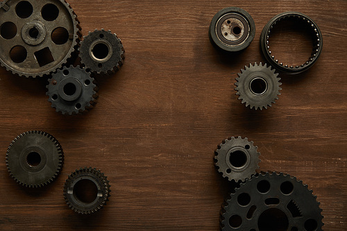 top view of aged gears on wooden table