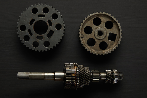 top view of aged gears on black surface