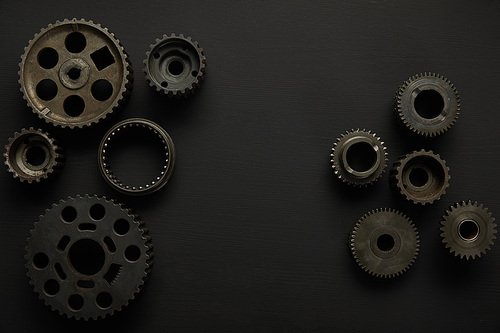 top view of aged gears on black surface