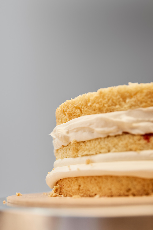 Close up view of tasty biscuit with cream isolated on grey